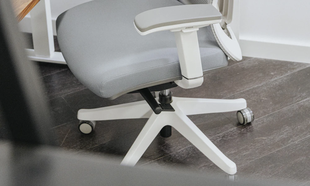 Gray ergonomic office chair beside a wooden desk in a modern home office