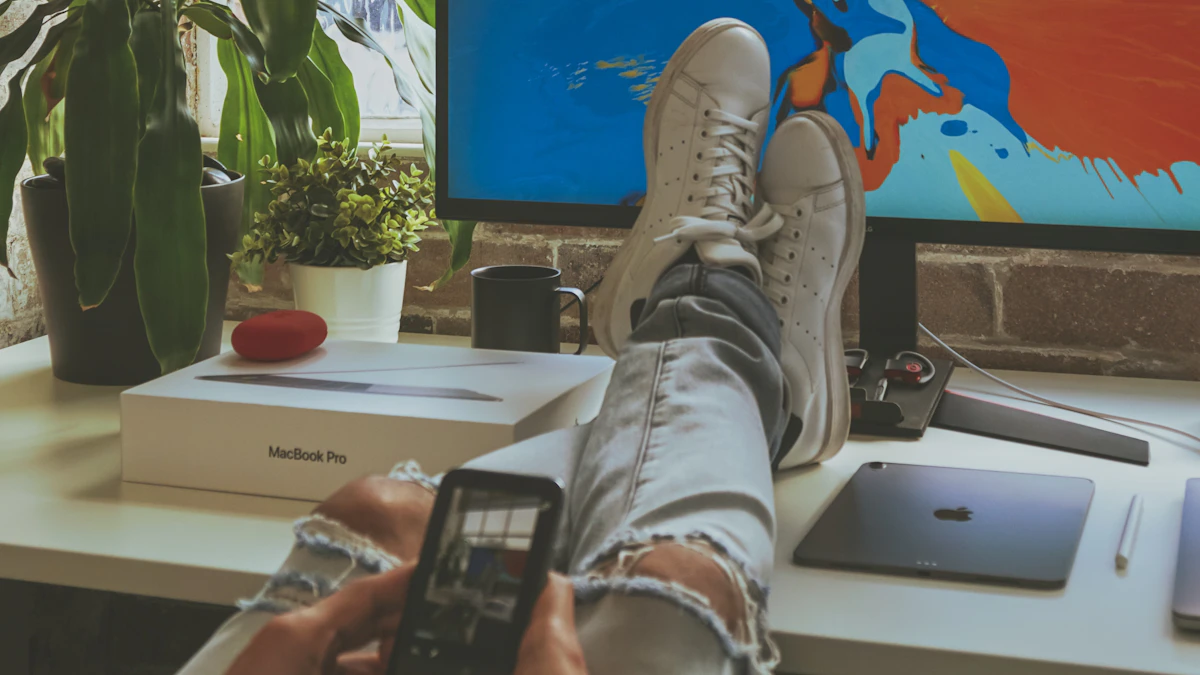Person sitting at a desk with both feet resting up on the desk surface, illustrating how foot position affects sitting posture