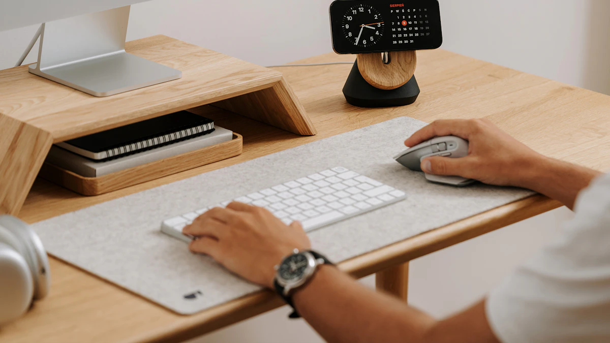 Correct Keyboard Tray Height and Angle 1 Person typing at a desk with hands resting on a keyboard, illustrating correct keyboard tray height and wrist position