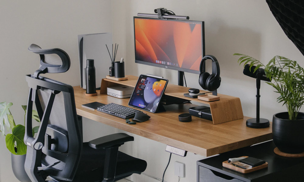 Wooden desk with a computer monitor and keyboard, a typical single-monitor setup for a desk converter