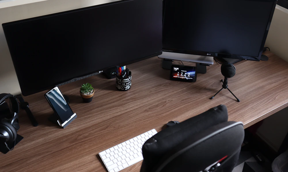 Computer desk with two monitors and a keyboard, a typical dual monitor workstation