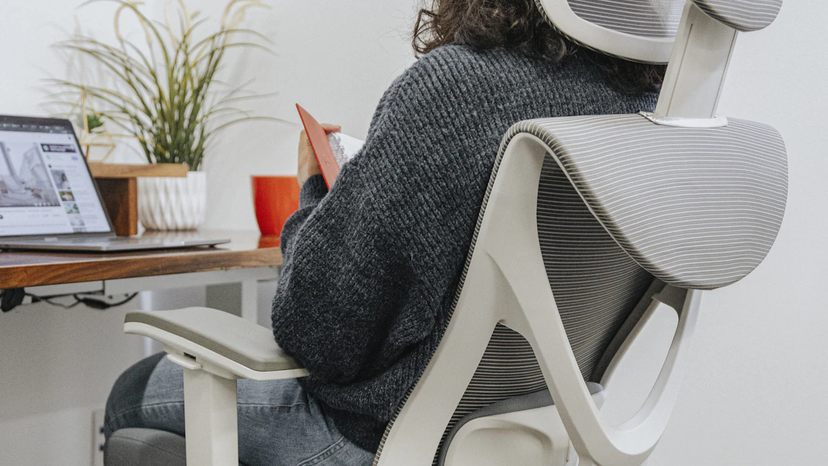 Woman sitting in an ergonomic office chair with visible lumbar support and contoured backrest at a home office desk