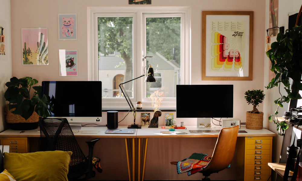 Desk with two computer monitors and a chair in a home office, a typical external monitor setup