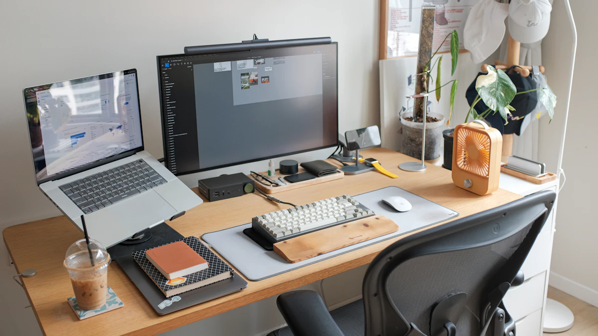 Desk setup with a laptop next to a computer monitor, the kind of fixed daily workstation where a sturdier laptop stand holds up better