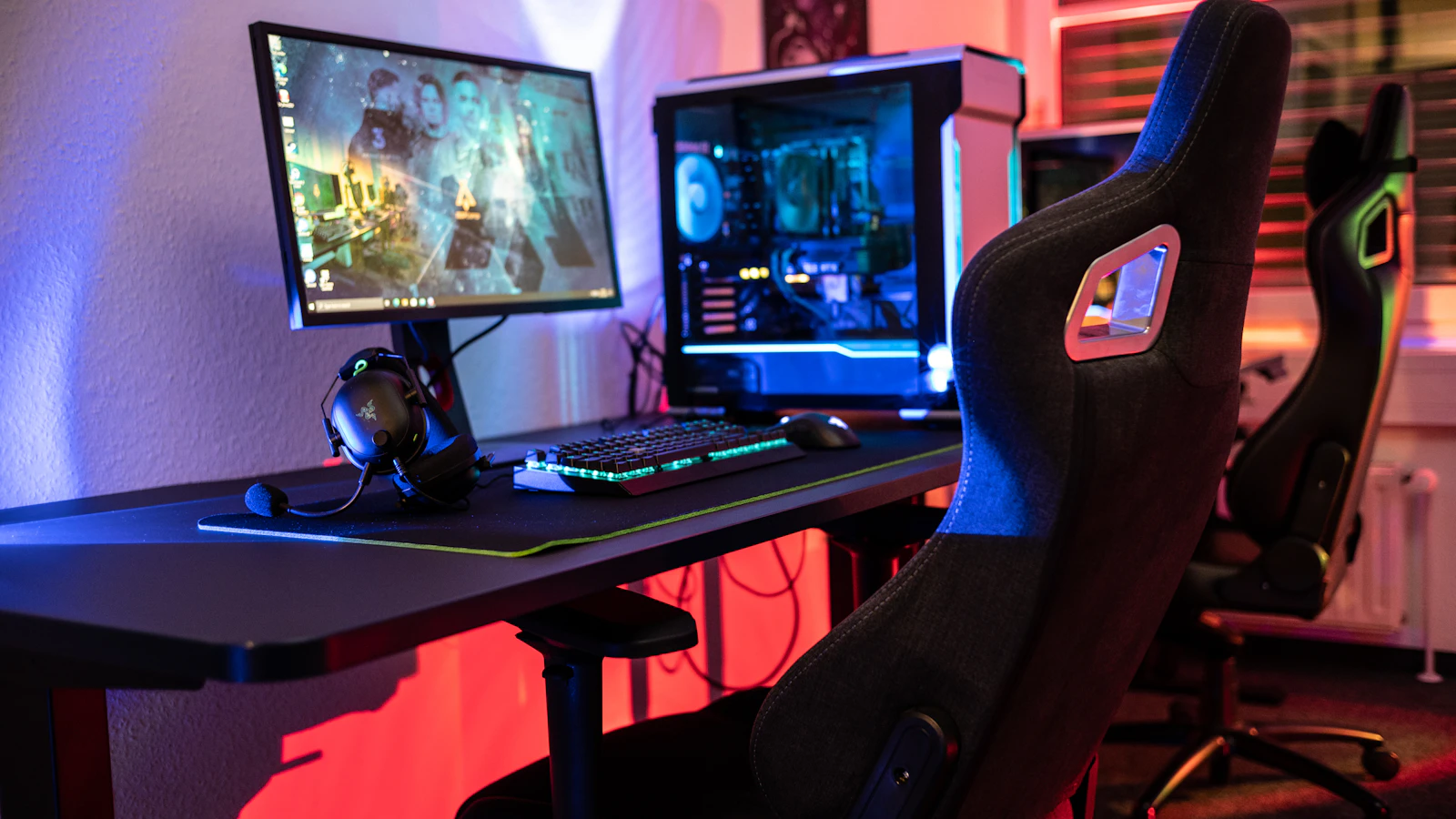 Gaming chair and desk setup with a computer, the kind of racing-style seat often compared to ergonomic office chairs