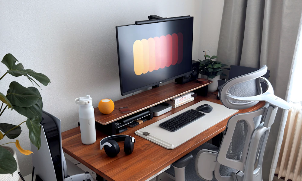 Modern gaming desk setup with a laptop and accessories, representative of a heavier laptop that needs a higher-rated stand