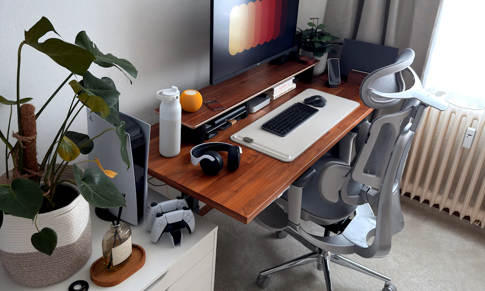 Modern home office desk setup with a chair, computer, and organized accessories