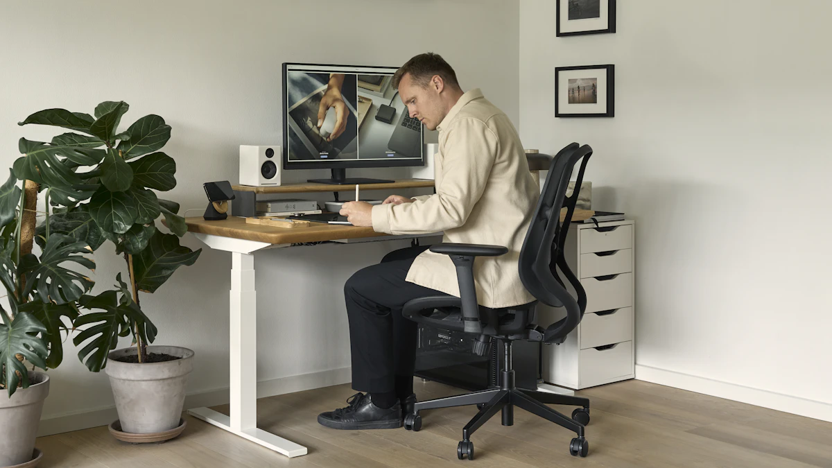 Kneeling Chair vs Standard Office Chair for Back Pain 1 Professional seated at a desk workstation with a computer, the kind of daily seating a kneeling chair or standard office chair needs to support