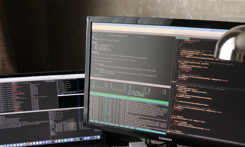 Person working at a desk using both a laptop and an external monitor side by side