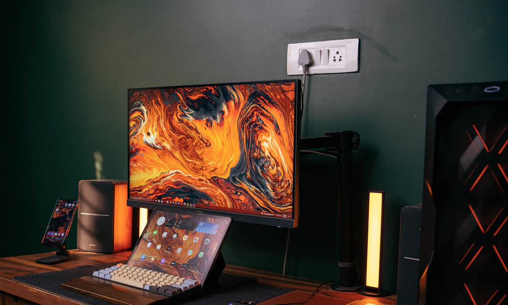 Wooden desk with a laptop next to a single external monitor, keyboard, and mouse
