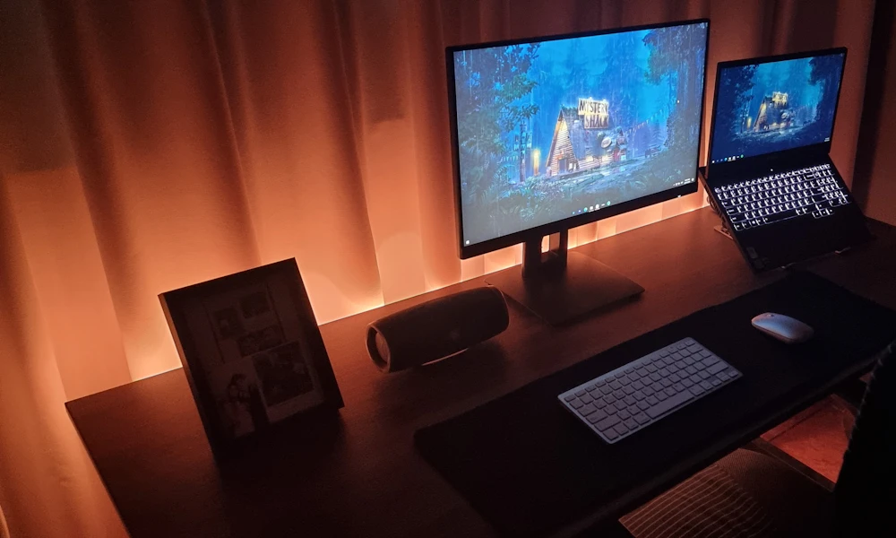 Desk with both a computer monitor and a laptop side by side, a common setup where a laptop stand keeps the laptop screen at a usable height