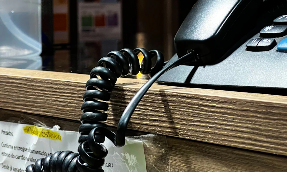 Charging cable resting on a desk surface, the kind of loose cord a standing desk cable spine is meant to secure