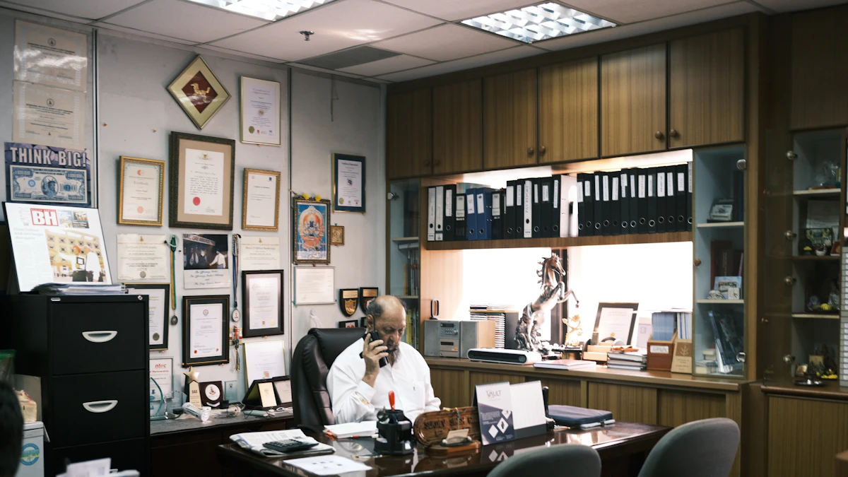 Person sitting in a black office chair at a desk, the kind of everyday use where a chair too small for the user's frame becomes obvious