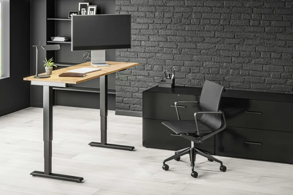 What Is a Standing Desk Memory Preset, and Do You Need One? 2 Monitor and keyboard set up on a wooden standing desk at a fixed working height