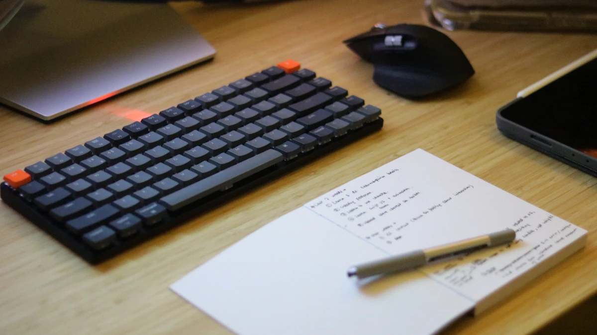 Organized desk with a keyboard, mouse, and notepad, the kind of workspace where a track or trackless keyboard tray gets installed